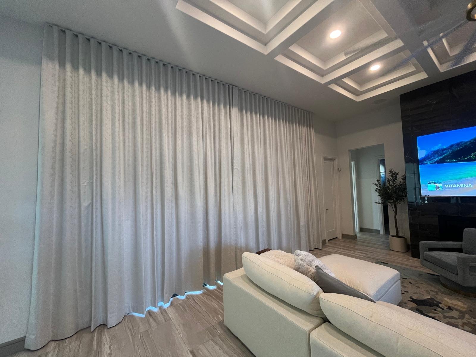 Wave-pleat fabric drapery in a living room