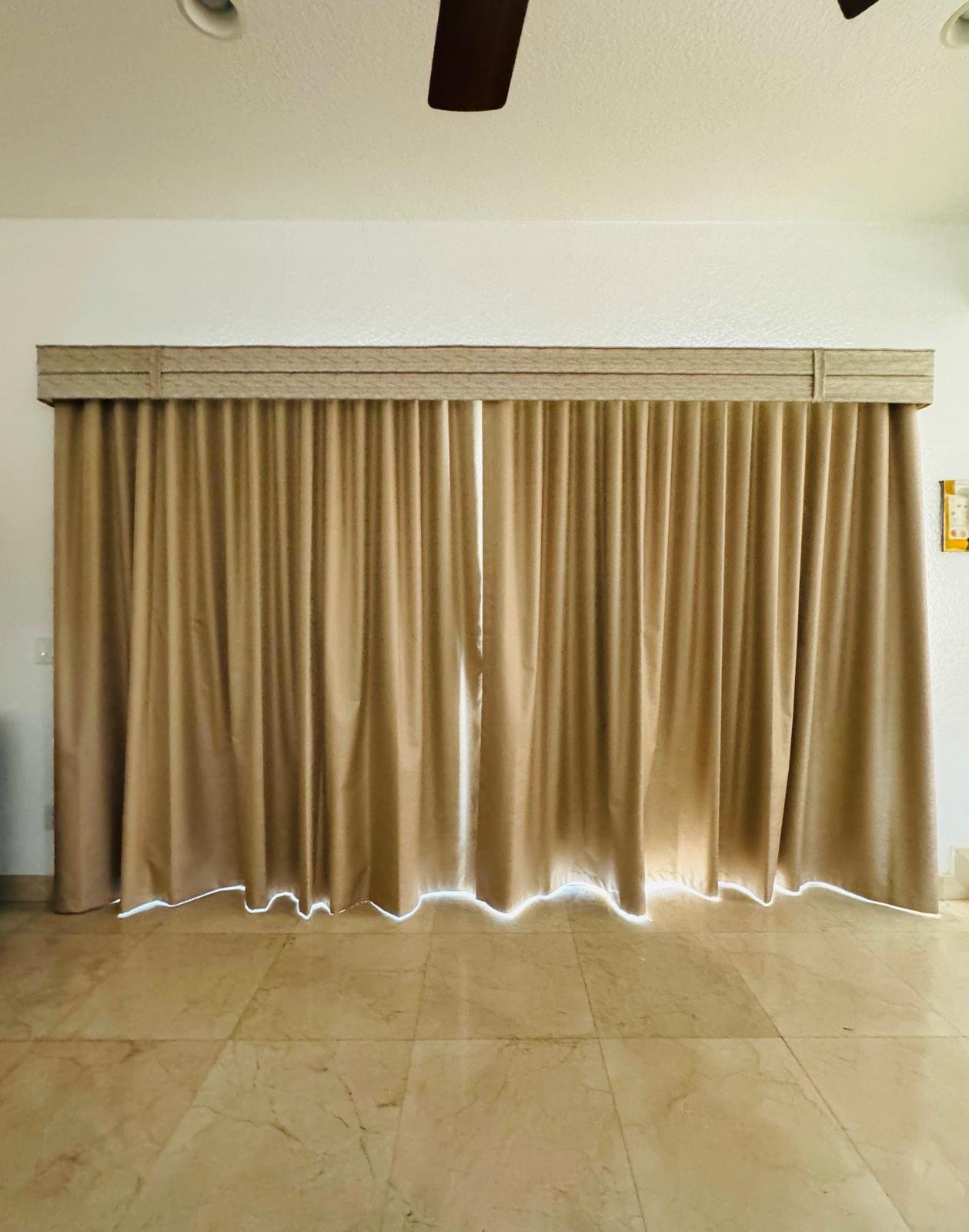 Camel fabric drapery with a tailored valance in a living room