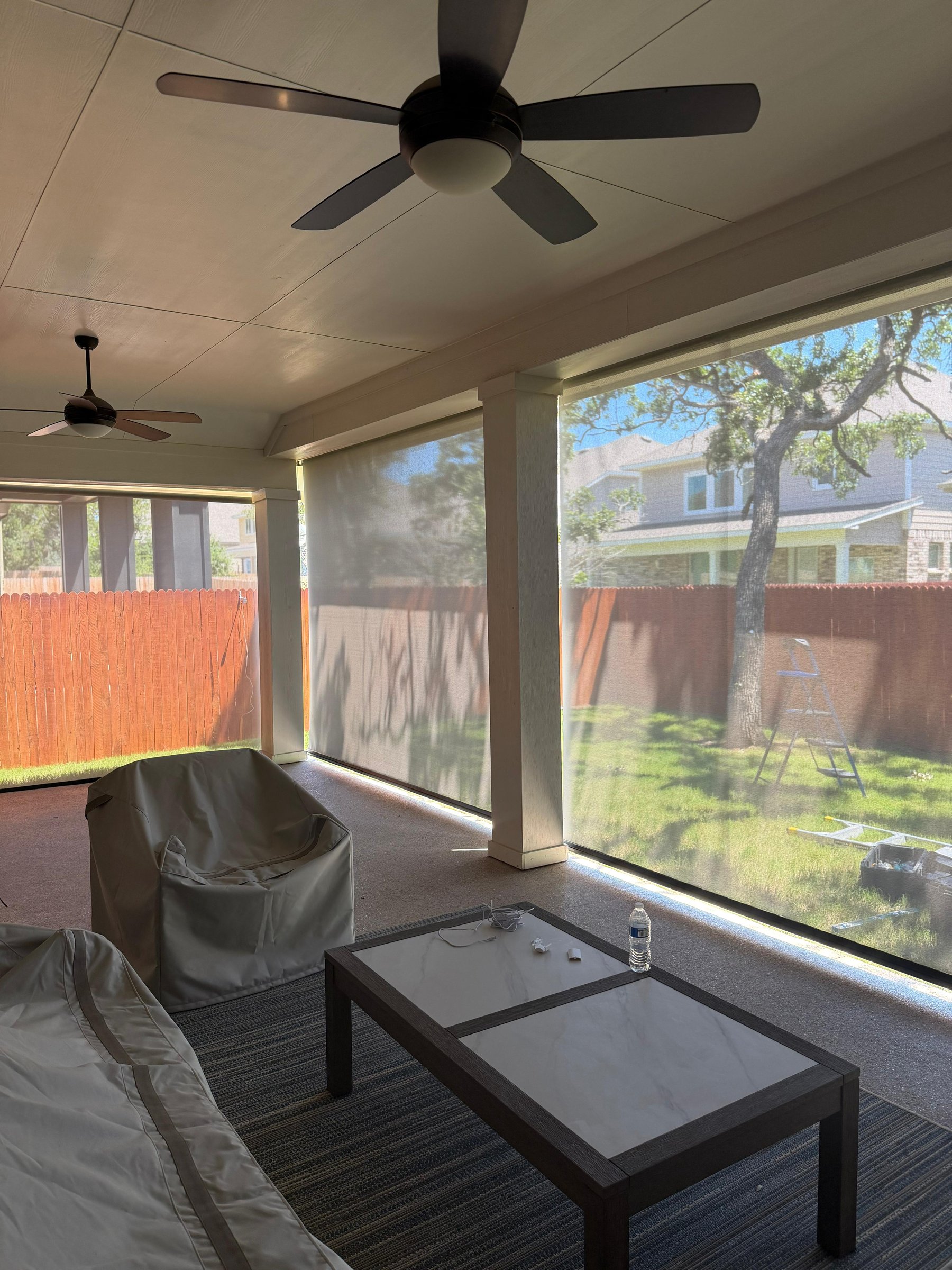 Translucent solar screen on a pergola with covered furniture