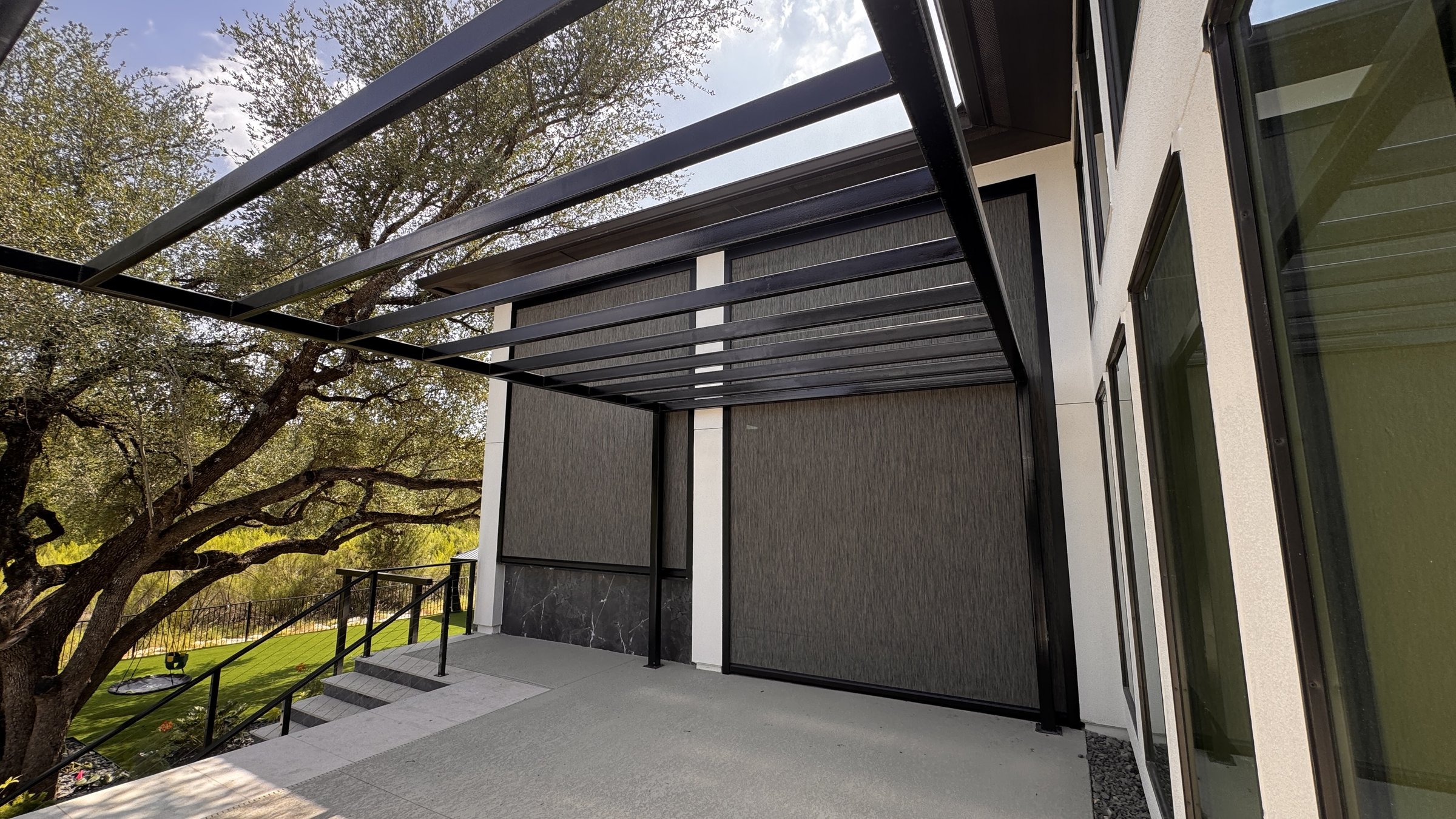 Graphite solar screen on a pergola, full view