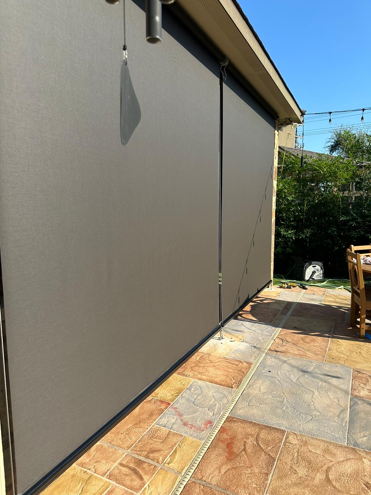 Graphite solar screen on a terrace beside a pool