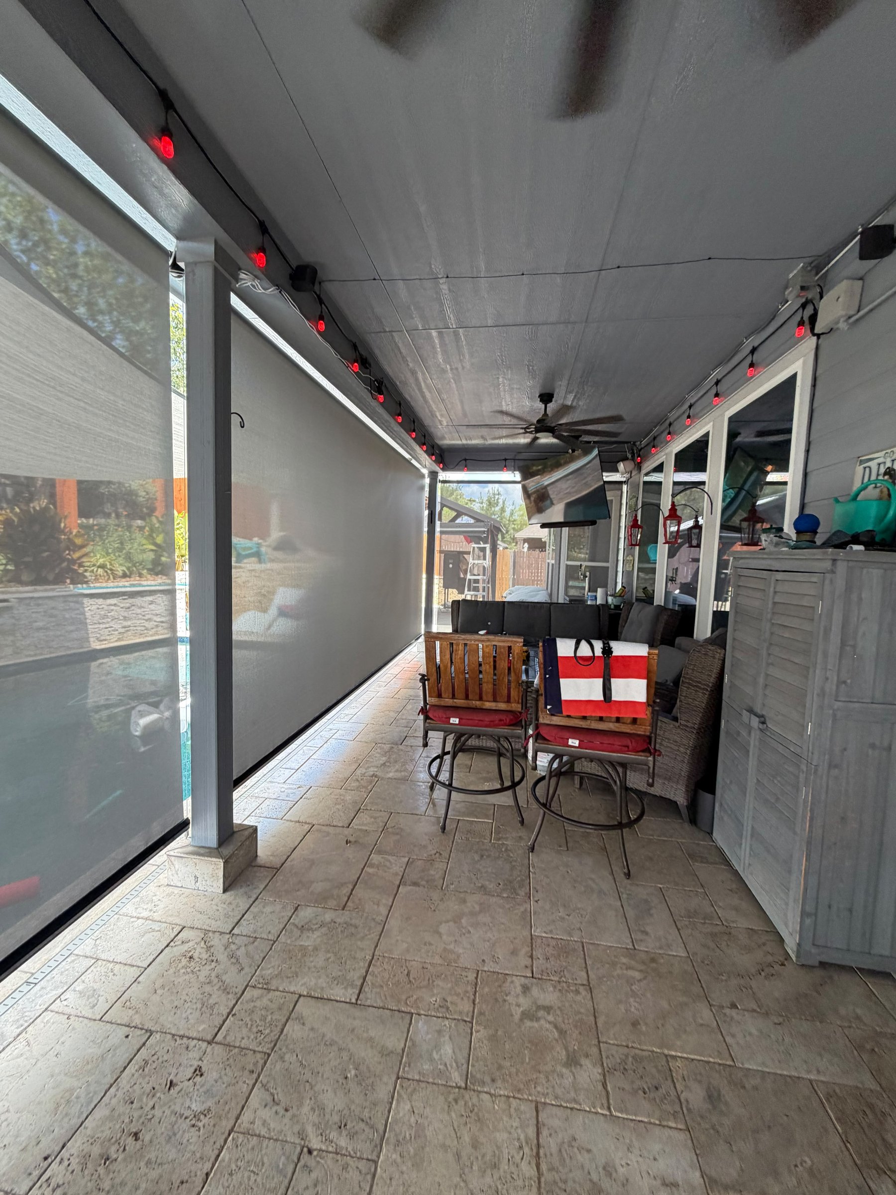 Light gray solar screen on a covered terrace