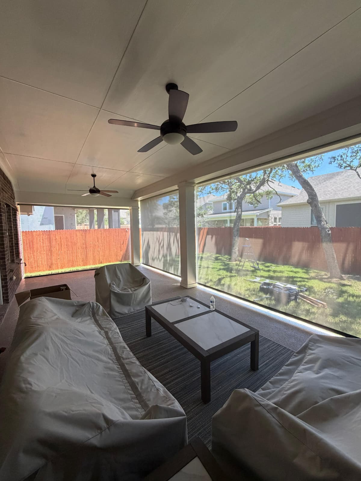 Translucent solar screen on a pergola with patio furniture