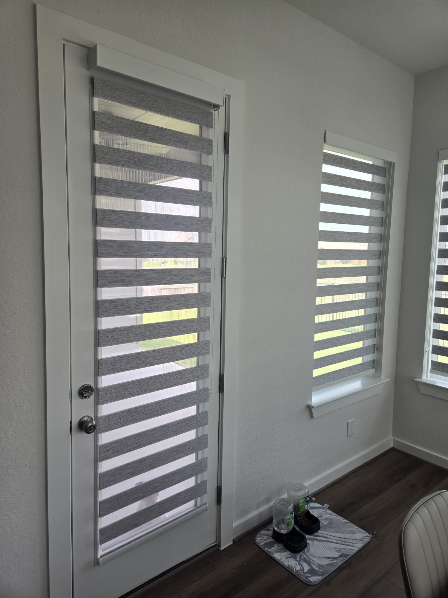White zebra shade beside an interior door
