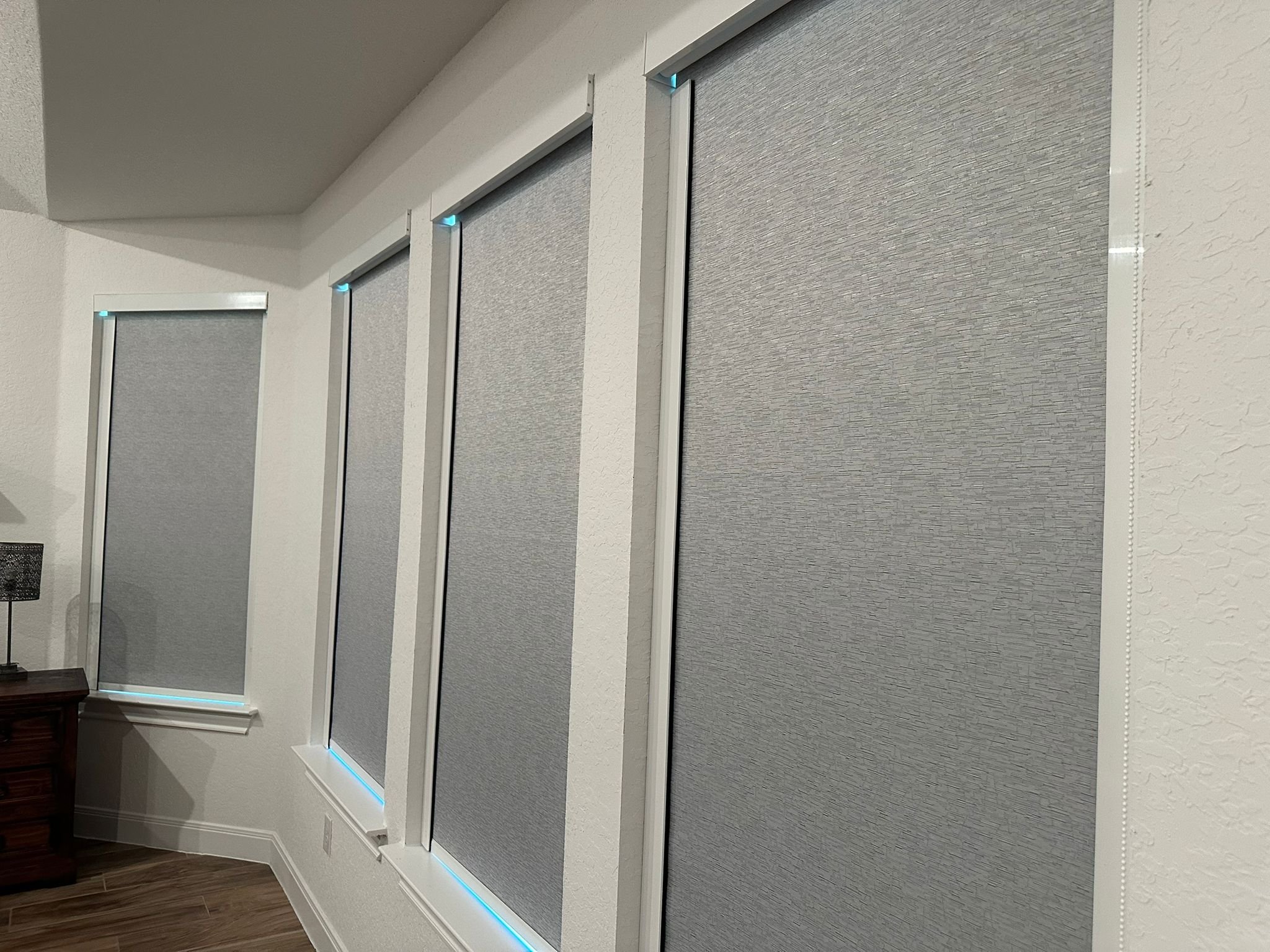 White zebra shades across three windows