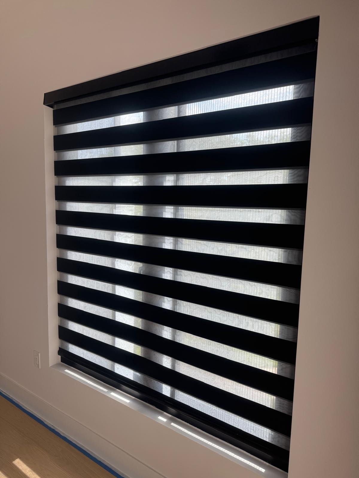 Navy zebra shade in a bedroom corner